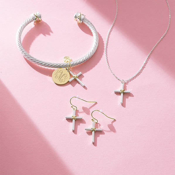 cable cross necklace bracelet and earrings on pink