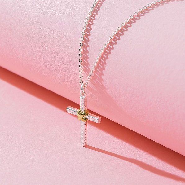cable cross necklace detail shot on pink