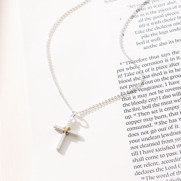 cable cross necklace on paper