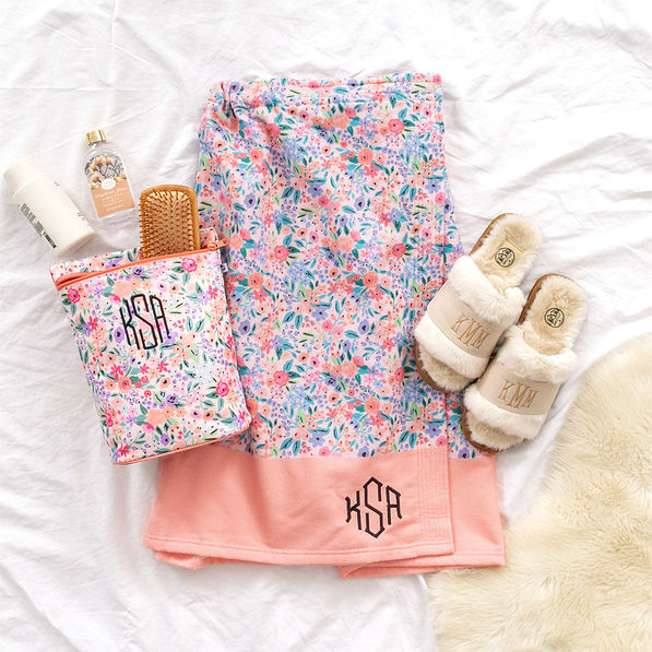 https://images.marleylilly.com/profiles/ml-product-detail/product/21515/zq8-coral-floral-towel-wrap-with-coral-floral-ditty-bag-slippers-fur-rug-on-sheet.jpg
