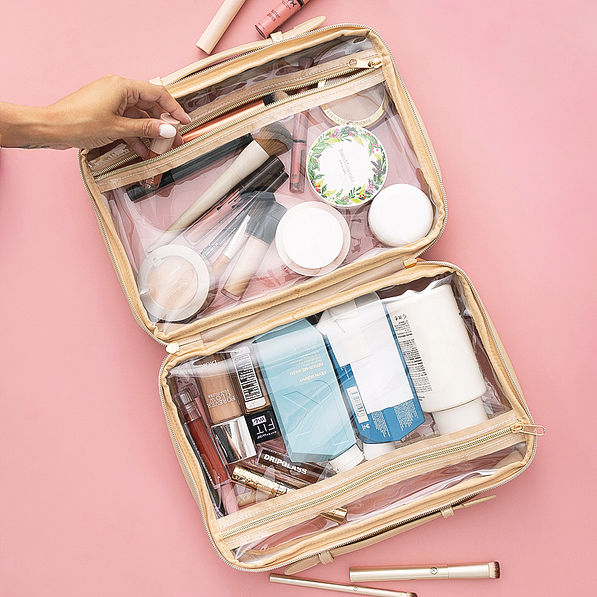 inside of monogrammed large clear toiletry case in gold