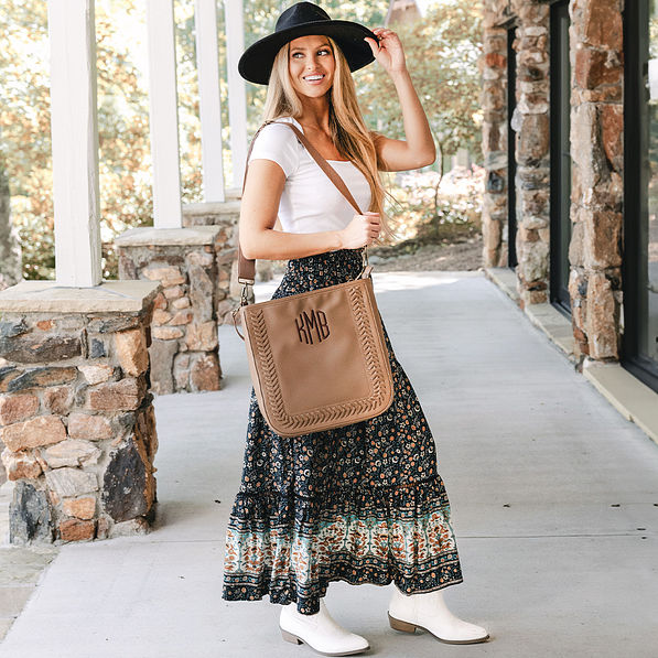 girl carrying monogrammed whipstitch brown purse over shoulder with midi skirt