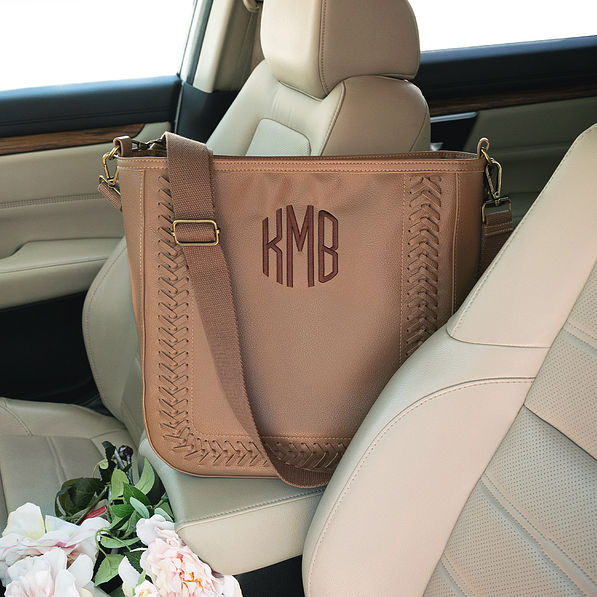 whipstitch monogrammed purse in car