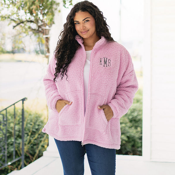 girl wearing full zip sherpa jacket in light pink