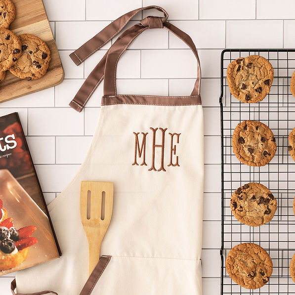 ivory monogrammed canvas apron with kitchen supplies and cookies