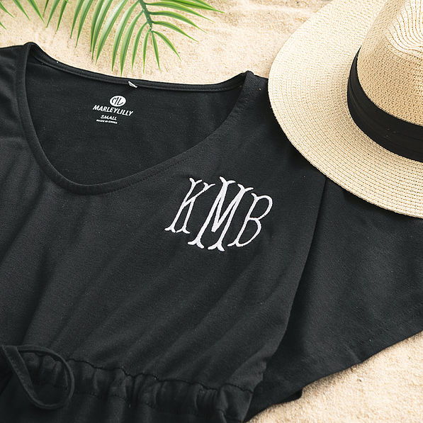 close up of monogrammed cinch waist cover up in black
