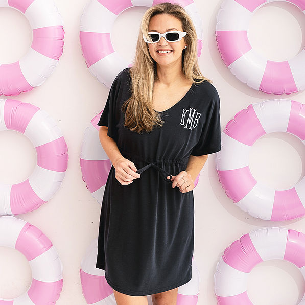girl wearing personalized cinch waist cover up in black with beach floaties
