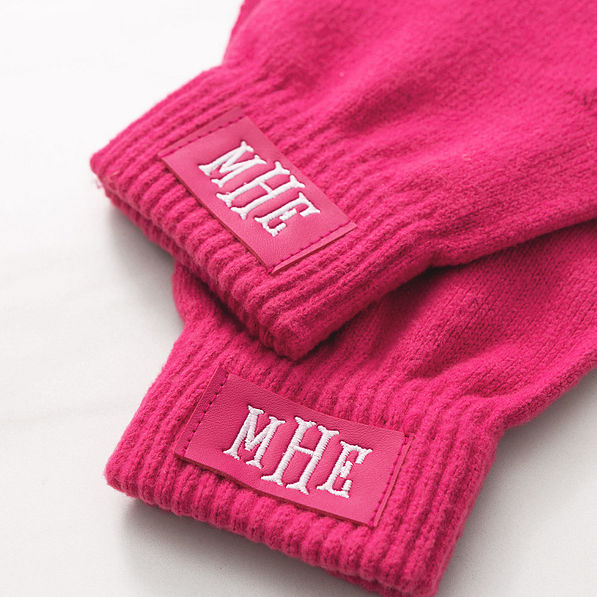 close up of monogrammed hot pink gloves