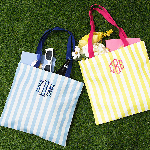 blue and yellow striped totes on grass