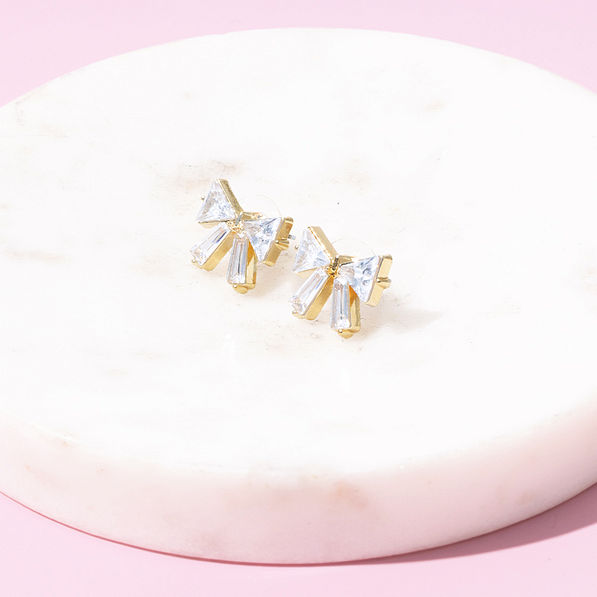 crystal bow earrings on marble