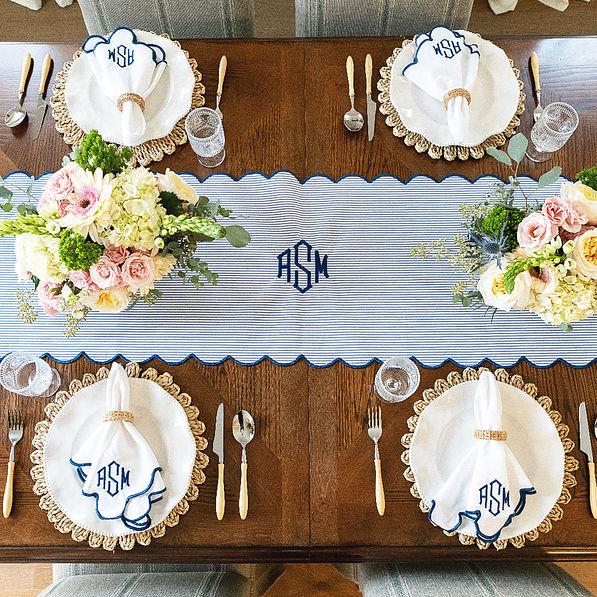 navy seersucker scalloped table runner on table with settings