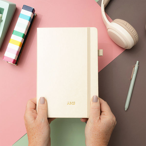 light tan notebook in hands