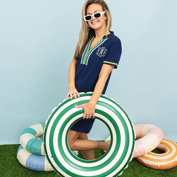girl wearing navy personalized ric rac cover up with pool float