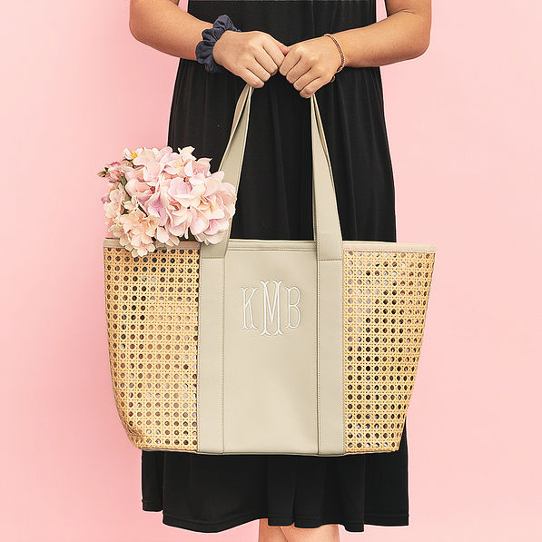 girl carrying monogrammed caning tote bag with flowers