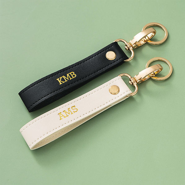 black and ivory classic keychains on green