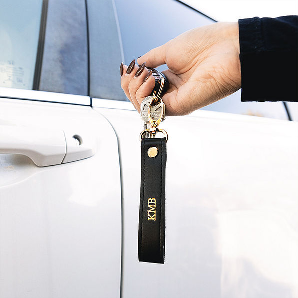 black classic keychain over white car