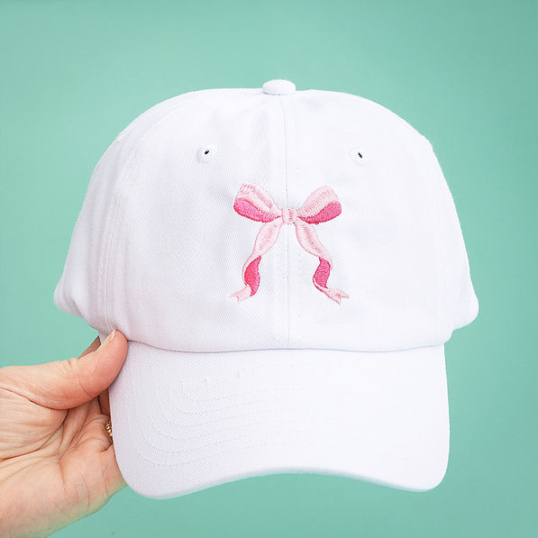 bow baseball hat on green background