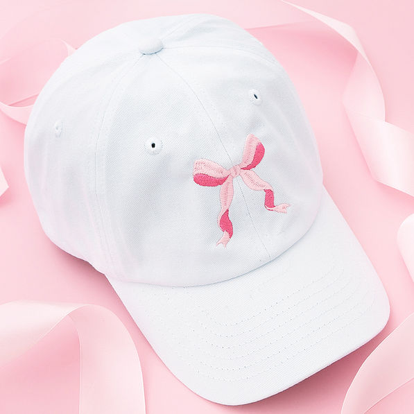 pink bow baseball cap on pink background
