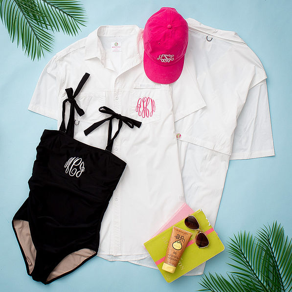 front and back of white monogrammed fishing shirt with black one piece swimsuit
