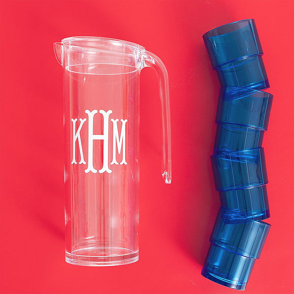 blue acrylic pitcher with nesting cups on red