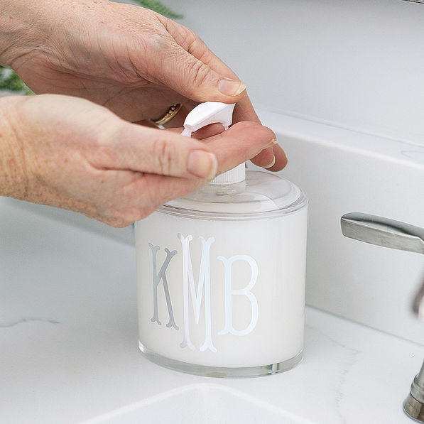 monogrammed clear soap dispenser being used