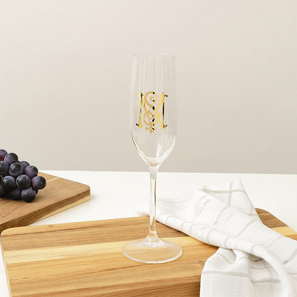 Personalized acrylic champagne glass empty on table
