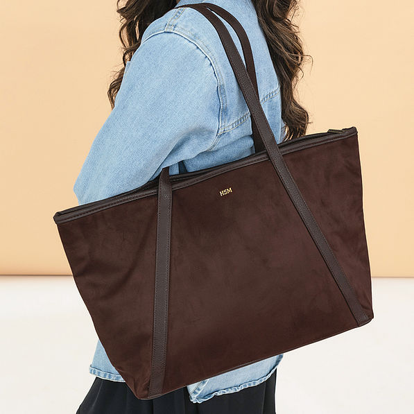 brown suede tote on shoulder