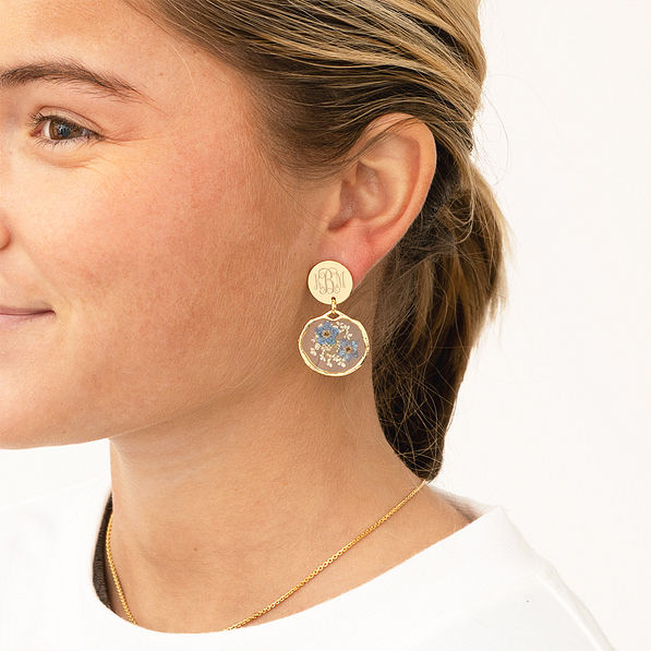 girl wearing forget me not earrings