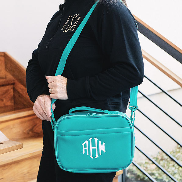 girl carrying personalized neoprene lunch bag in teal over shoulder