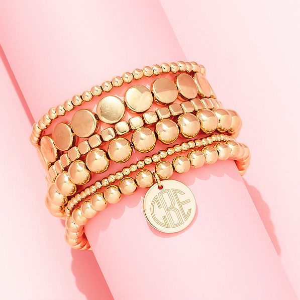 gold lightweight bracelets on pink