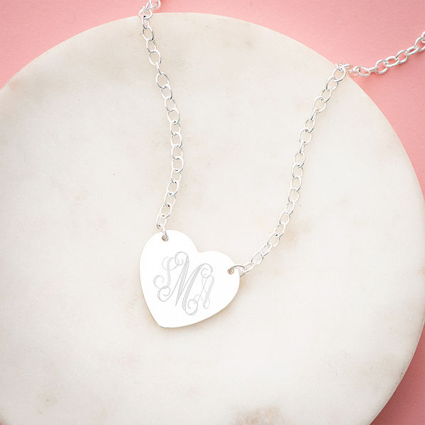silver heart pendant necklace on marble dish