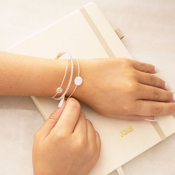 Girl wearing rhinestone bangle with notebook