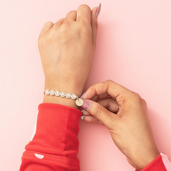 Girl wearing monogrammed rhinestone heart bracelet