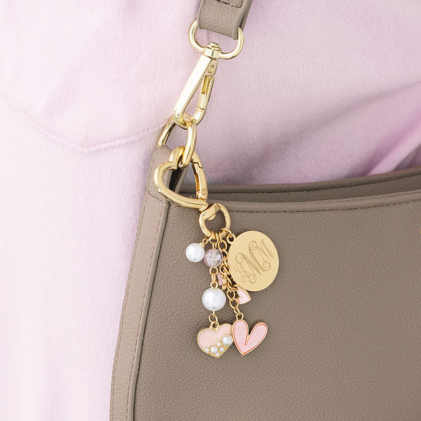 personalized gold bag charm keychain on shoulder bag
