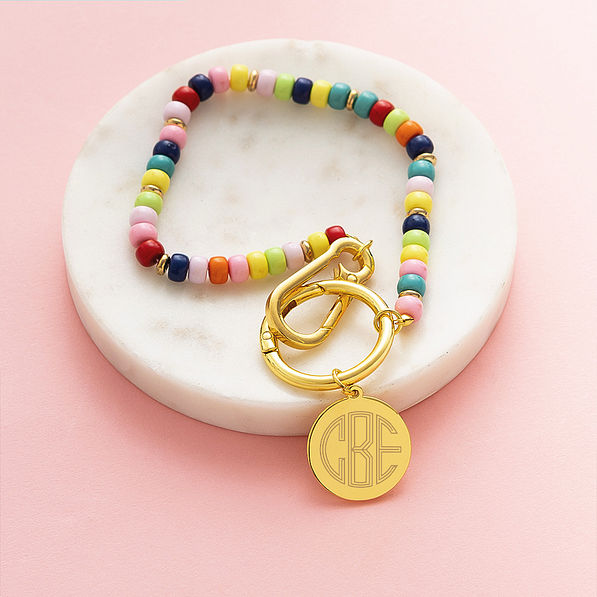 multi bag charm keychain on marble dish