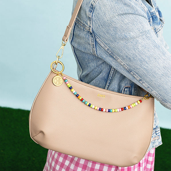 multi bag charm keychain on shoulder bag worn by girl