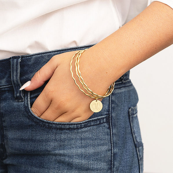 Girl wearing Gold scalloped Bangle set
