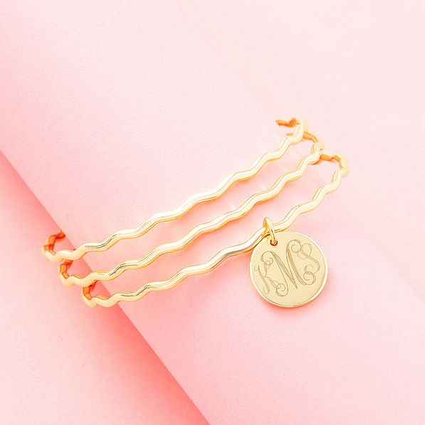 gold scalloped bangle set on pink