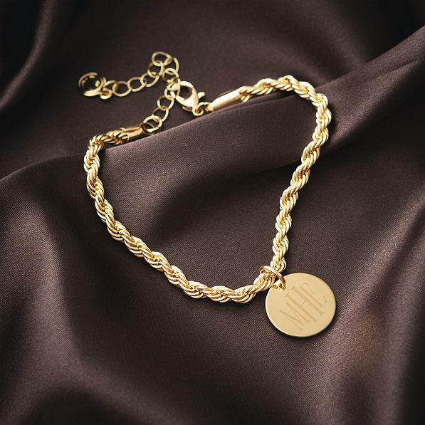 close up of gold monogrammed twisted rope bracelet