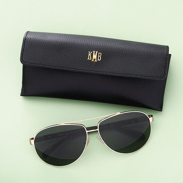 black sunglasses case on green background