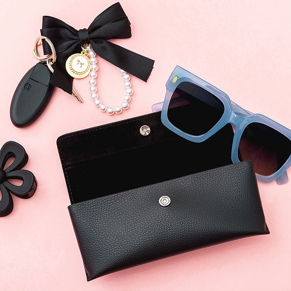 black sunglasses case on pink background