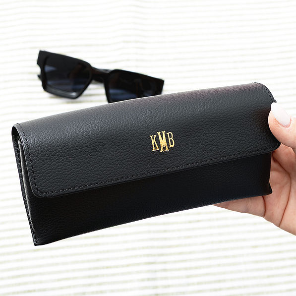 black sunglasses case in hand