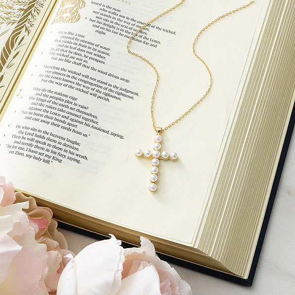 Pearl cross necklace on bible