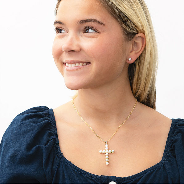 girl wearing pearl cross necklace and 8mm earrings