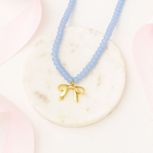 Beaded bow necklace on marble