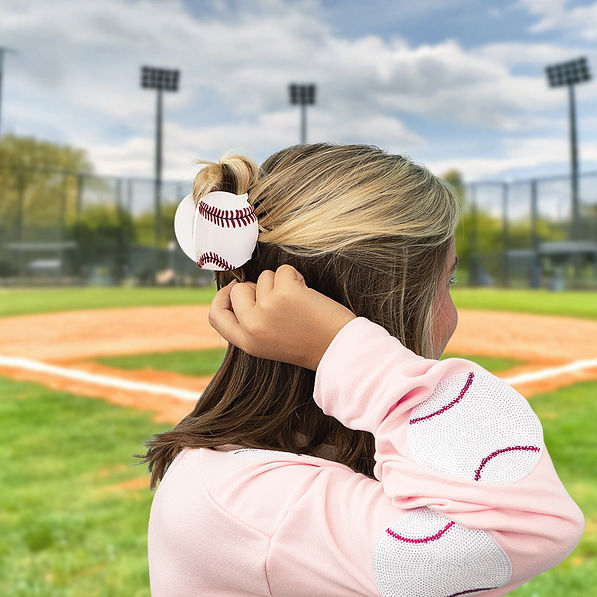 Ava wearing baseball hairclip at baseball game