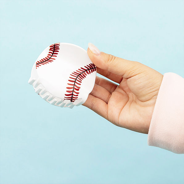 hand holding a baseball hair clip
