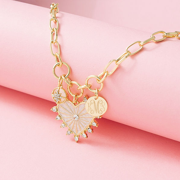 Charm heart necklace on pink detail shot