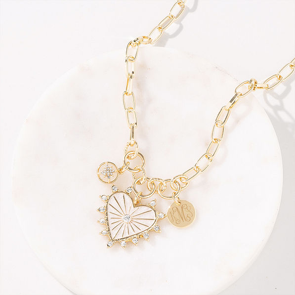 Charm heart necklace on marble dish