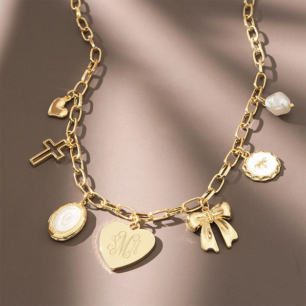 gold charm necklace on brown background